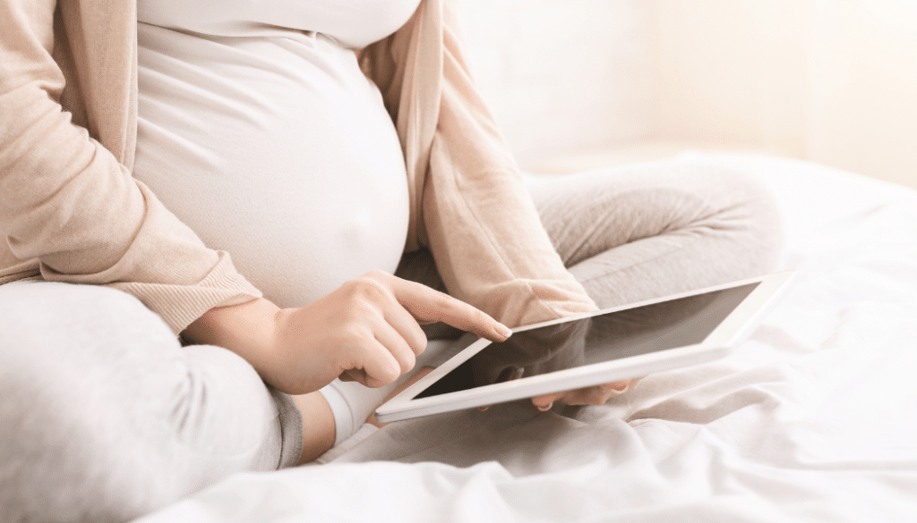 femme enceinte navigant sur tablette